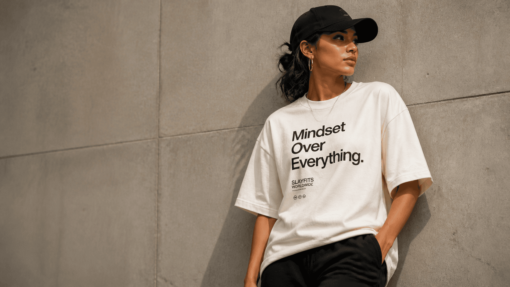 Model wearing a SLAYFITS tee in a relaxed, casual setting